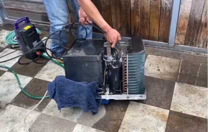 Lake Jackson AC technician cleaning unit